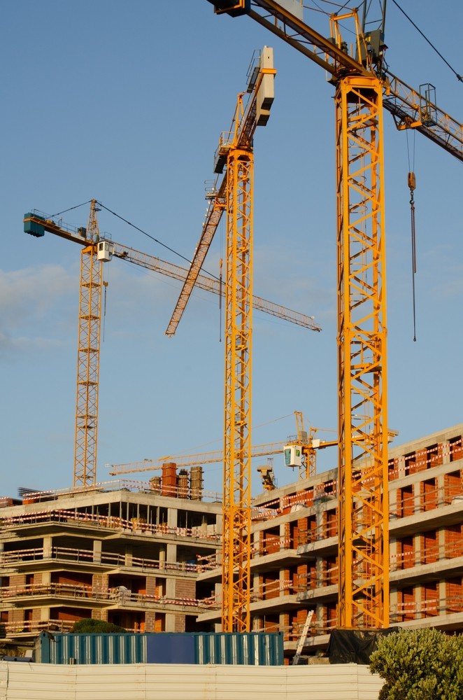 Tower cranes over a concrete frame under construction