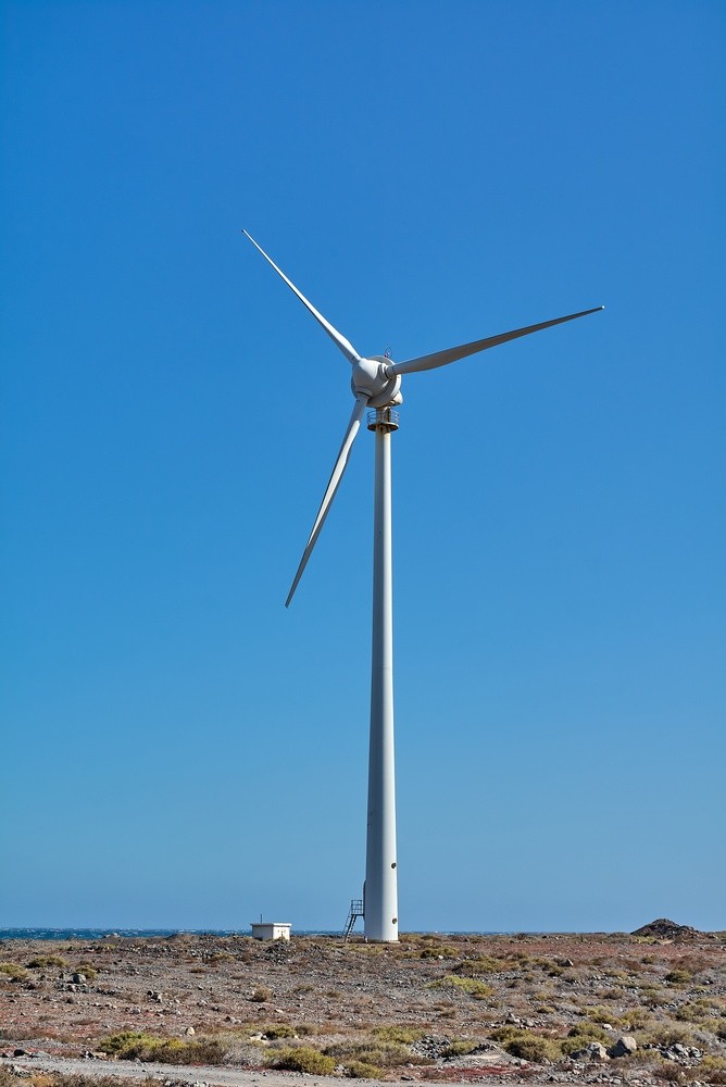 A single wind turbine on open coastal ground